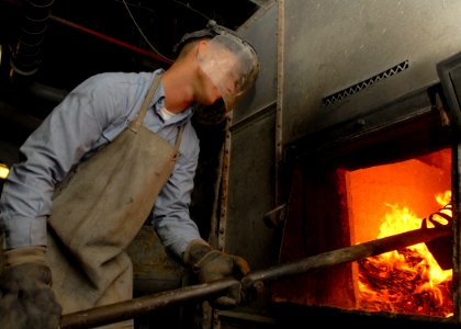 US Navy 081003-N-2456S-020 Aviation Electronics Technician Airman Eric Syck burns trash in the incinerator aboard the aircraft carrier USS Theodore Roosevelt (CVN 71)