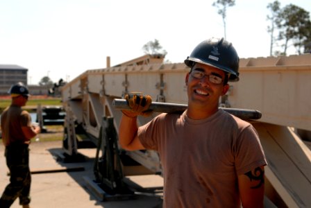 US Navy 080930-N-3674H-052 Construction Electrician 2nd Class Edward Hutton attaches a section of a medium girder bridge
