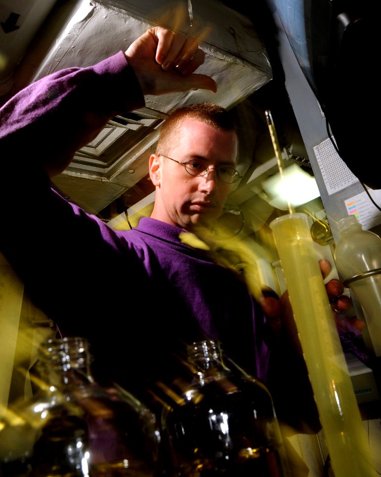 US Navy 081005-N-9898L-037 Aviation Boatswain's Mate (Fuel) 3rd Class Michael Owens, from Olathe, Kan., tests a sample of JP-5 jet fuel aboard the aircraft carrier USS Abraham Lincoln (CVN 72) during an underway replenishment