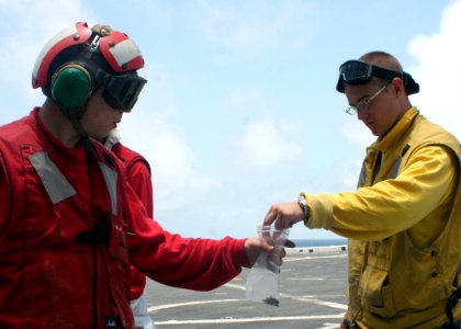 US Navy 080930-N-6764G-004 Aviation Boatswain's Mate (Handling) Airman Mike Kreciak collects debris from Aviation Boatswain's Mate (Handling) 3rd Class Daniel Lloyd during a foreign object damage walk-down