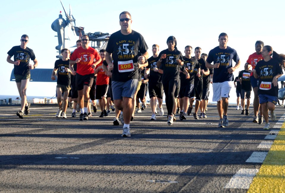 US Navy 101213-N-4378P-049 Sailors and Marines participate in the Lady Ace 5K run on the flight deck of the amphibious assault ship USS Peleliu (LH