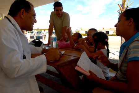 US Navy 081004-N-3595W-152 Dominican Republic Navy 2nd Lt. Rafael Azconal, left, an orthopedist, works with Air Force Tech. Sgt. Dennis Leon from the amphibious assault ship USS Kearsarge (LHD3) to help local patients