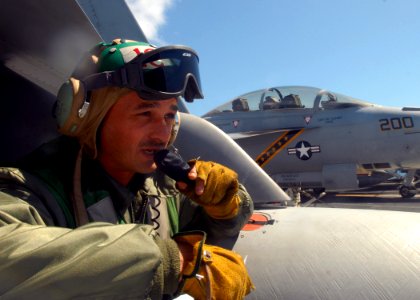 US Navy 081001-N-2456S-126 Chief Aviation Structural Mechanic Johnny Medovich, a flight deck coordinator assigned to the