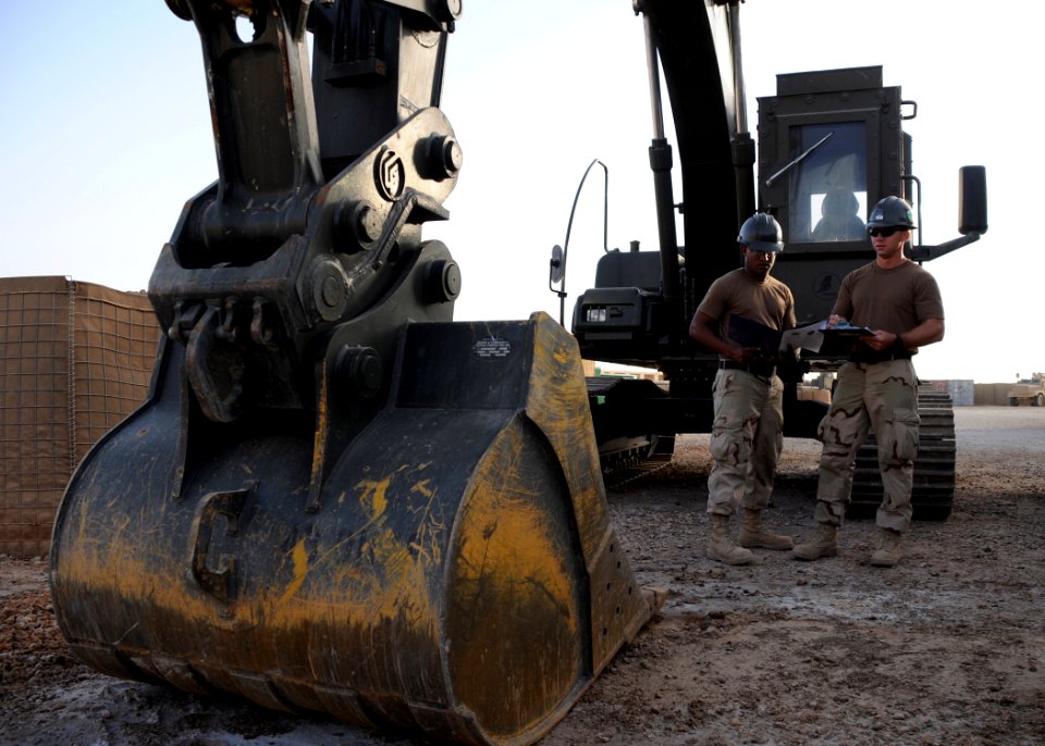 US Navy 081006-N-1120L-016 Equipment Operator 2nd Class Gerald Flint and Equipment Operator Constructionman Apprentice Toriano Frick conduct equipment checks on an excavator