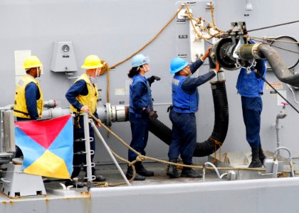 US Navy 081001-N-2183K-104 Crew members aboard the guided missile destroyer USS Halsey (DDG 97) connect the fuel probe during a refueling at sea