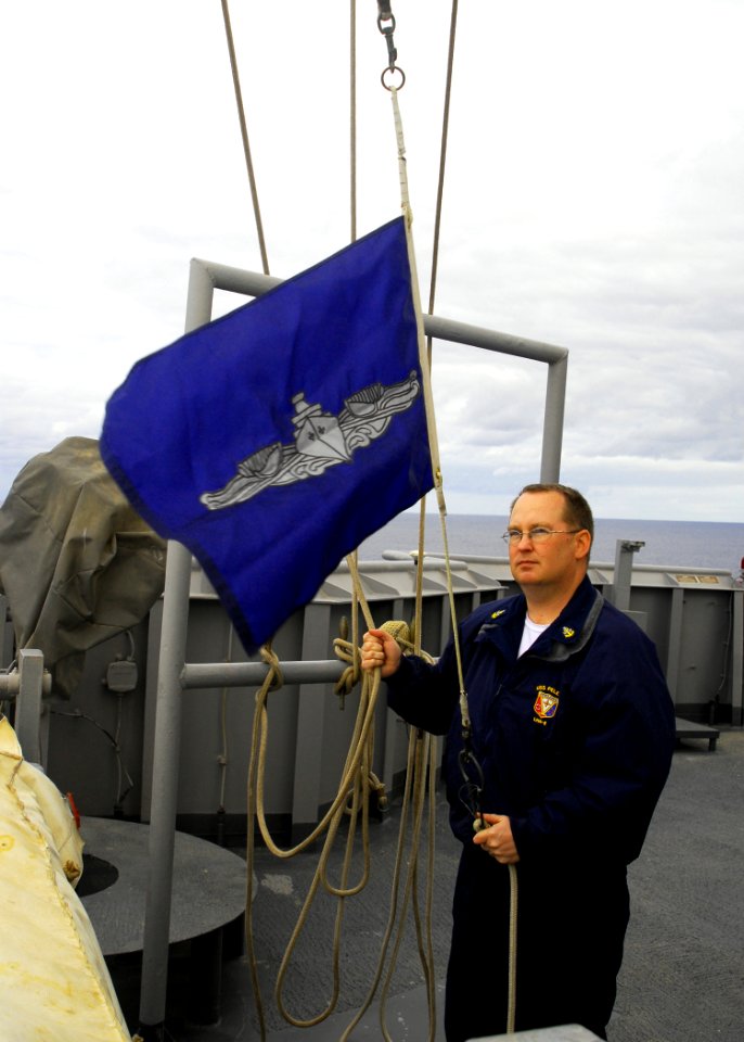US Navy 081001-N-5148B-011 Senior Chief Quartermaster Joseph Lennon raises the Enlisted Surface Warfare Pennant