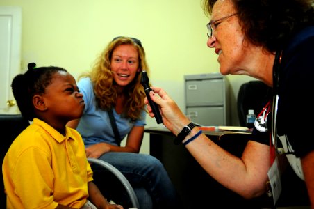 US Navy 081004-N-4515N-031 Project HOPE volunteer, Lydia Segal, embarked aboard the amphibious assault ship USS Kearsarge (LHD 3), gives a child a routine physical