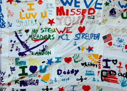 US Navy 081005-N-1522S-014 Family and friends a sign made from painted pillow cases welcoming Sailors assigned to the guided-missile frigate USS McInerney (FFG 8) home to Naval Station Mayport after a six-month deployment