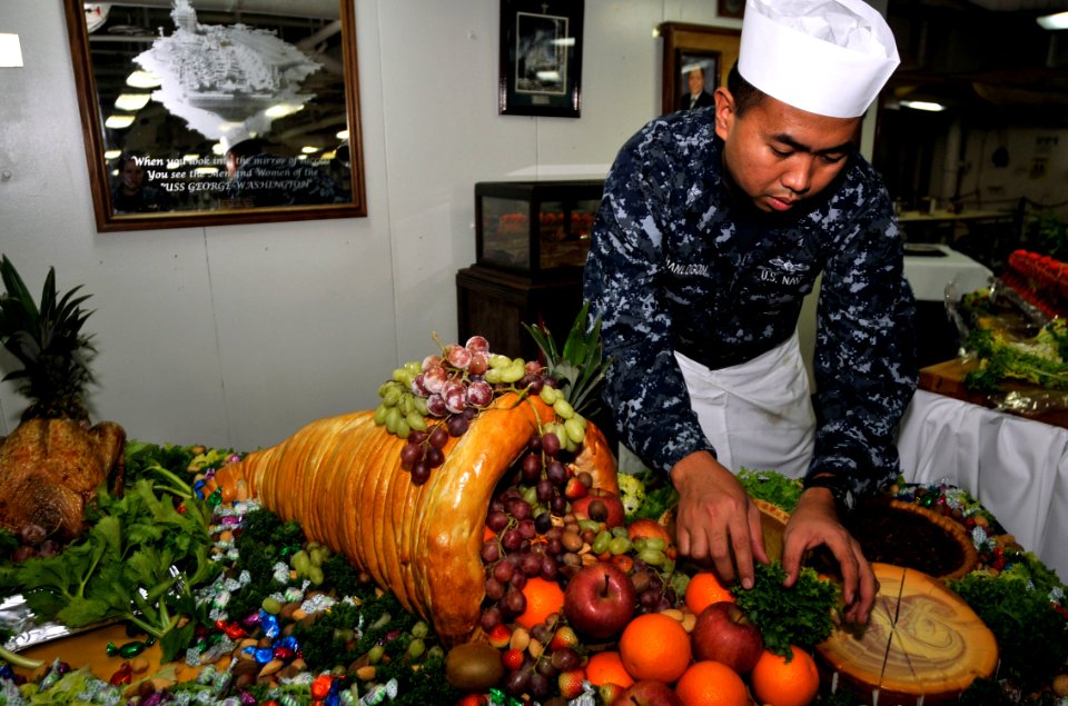 US Navy 101125-N-7103C-144 Culinary Specialist 1st Class Lemuel ManLogon from Stokton, Calif., prepares a traditional Thanksgiving feast