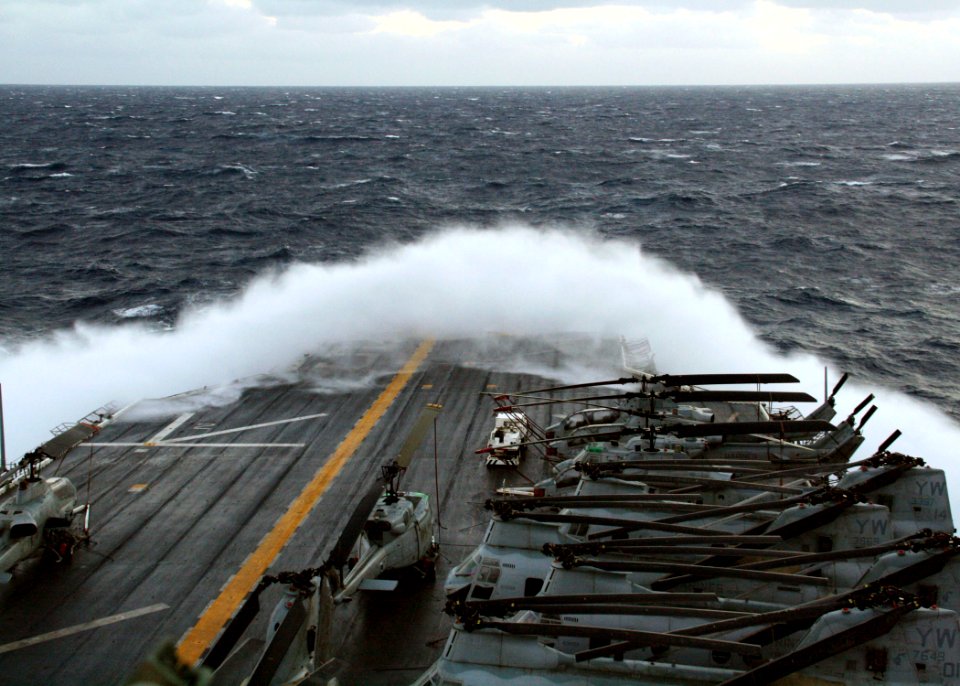 US Navy 081004-N-9299W-001 Large waves create sea spray over the bow of the amphibious assault ship USS Peleliu (LHA 5). Peleliu is deployed to the Navy's 7th Fleet area of responsibility