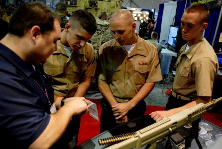 US Navy 081001-N-7676W-025 Jeffery Balisle explains the development of lightweight ammunition technologies to Marines photo