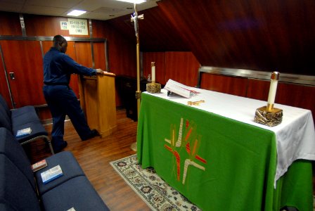 US Navy 081005-N-1635S-003 Religious Programs Specialist 3rd Class Jamal Lowe, from Columbia, Miss., cleans and prepares the chapel aboard the Nimitz-class aircraft carrier USS Ronald Reagan (CVN 76) to prepare for the Roman Ca