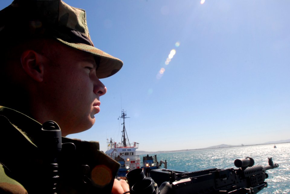 US Navy 081005-N-2456S-015 Information Systems Technician 3rd Class Adam Hnanicek stands watch as he looks for possible surface contacts that may pose a threat to the aircraft carrier USS Theodore Roosevelt (CVN 71)