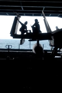 US Navy 081007-N-3610L-057 Two Aviation Structural Mechanics collaborate on the wing of a F-A-18C Hornet, assigned to the