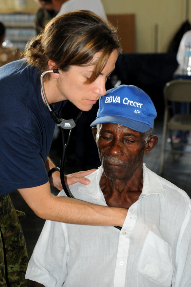 US Navy 081005-N-5642P-102 Canadian Air Force Capt. Jolene Cook, a medical augmentee embarked aboard the amphibious assault ship USS Kearsarge (LHD 3), gives a local man a general medical examination at the El Deporte y Recreac