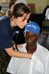 US Navy 081005-N-5642P-102 Canadian Air Force Capt. Jolene Cook, a medical augmentee embarked aboard the amphibious assault ship USS Kearsarge (LHD 3), gives a local man a general medical examination at the El Deporte y Recreac photo