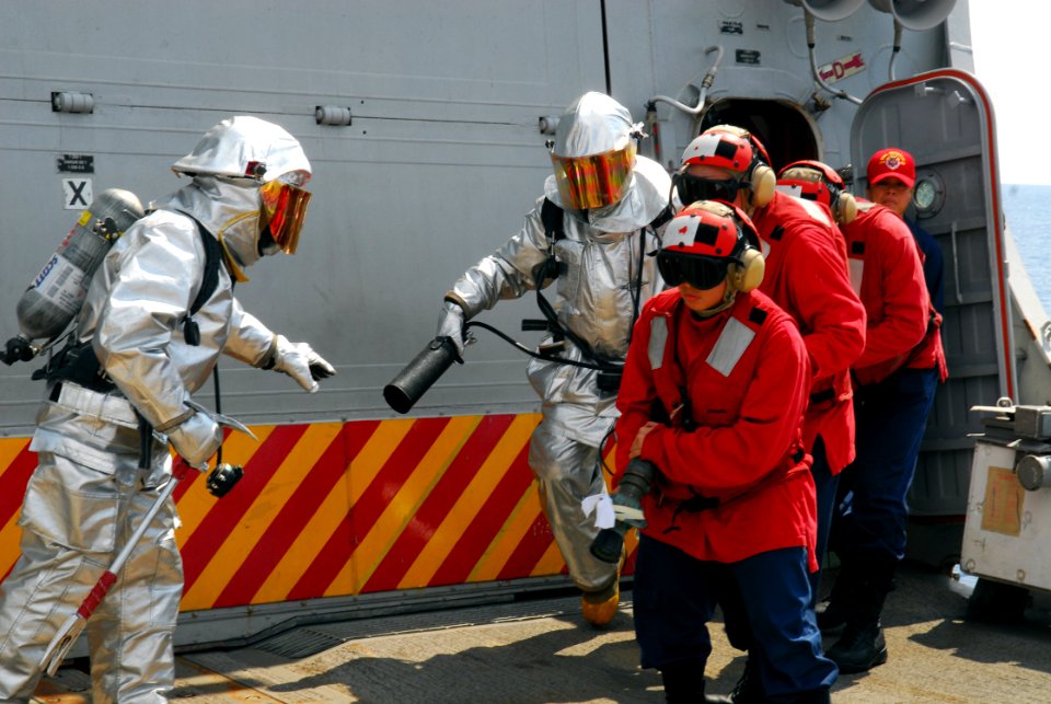 US Navy 081006-N-2013O-001 Sailors respond to a simulated fire