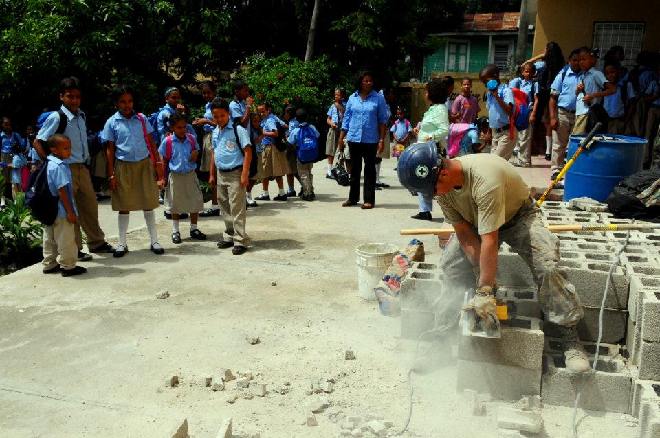 US Navy 081006-N-4515N-053 Air Force civil engineer Staff Sgt. Richard Monsalve cuts blocks for a construction project at Socorro Sanchez Primary School during a community service project