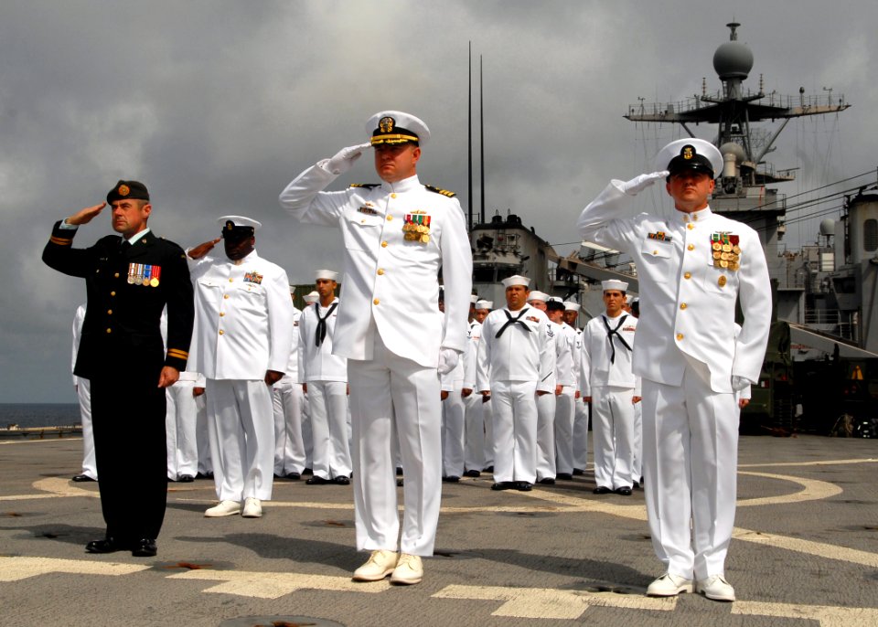 US Navy 081006-N-3392P-030 The official party render salutes in honor of a deceased Navy veteran during a burial at sea ceremony aboard the amphibious dock landing ship USS Carter Hall (LSD 50)