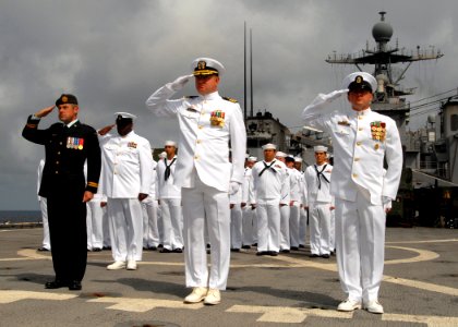 US Navy 081006-N-3392P-030 The official party render salutes in honor of a deceased Navy veteran during a burial at sea ceremony aboard the amphibious dock landing ship USS Carter Hall (LSD 50)