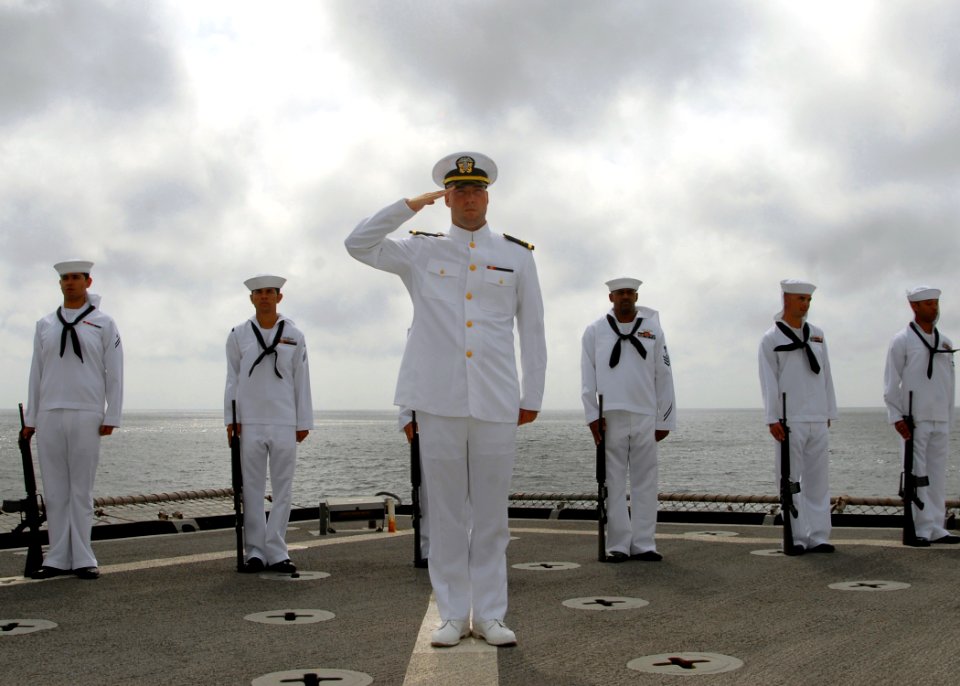 US Navy 081006-N-3392P-034 Sailors assigned to the ceremonial detail of the amphibious dock landing ship USS Carter Hall (LSD 50) render honors during a burial at sea for a deceased Navy veteran