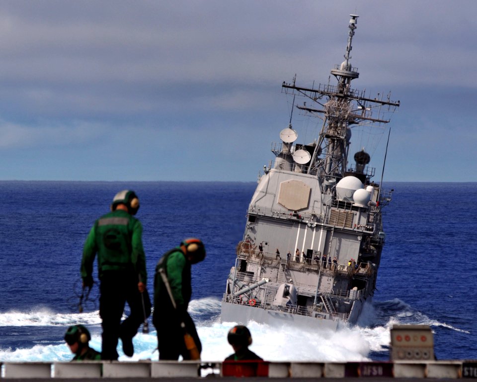 US Navy 081006-N-7981E-284 The Ticonderoga-class guided-missile cruiser USS Mobile Bay (CG 53) turns alongside the aircraft carrier USS Abraham Lincoln (CVN 72) as Air Department V-2 Division personnel prepare for flight operat