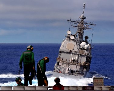 US Navy 081006-N-7981E-284 The Ticonderoga-class guided-missile cruiser USS Mobile Bay (CG 53) turns alongside the aircraft carrier USS Abraham Lincoln (CVN 72) as Air Department V-2 Division personnel prepare for flight operat