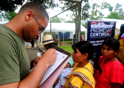 US Navy 101001-N-1531D-049 Cpl. Hector Reyes checks patients into a Continuing Promise 2010 medical community service event photo