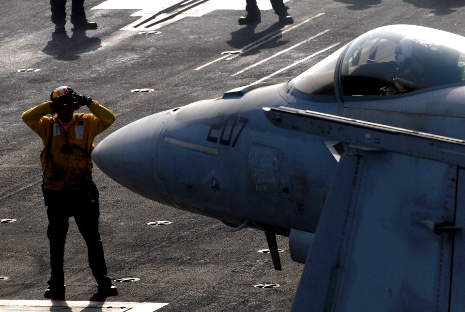 US Navy 081006-N-4995K-043 Aviation Boatswain's Mate (Handling) 1st Class Michael Dominguez taxis an F-A-18E Super Hornet assigned to the
