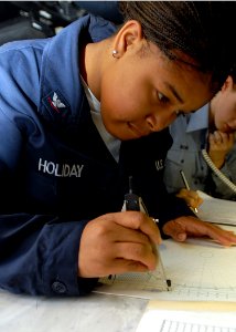 US Navy 081008-N-2456S-048 Operations Specialist 3rd Class Mellissa Holiday plots the ship's course and speed on a maneuvering board in the tactical operations plot on the bridge aboard the aircraft carrier USS Theodore Rooseve