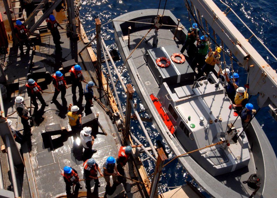 US Navy 081004-N-3392P-038 ailors hoist down a landing craft aboard the amphibious dock landing ship USS Carter Hall (LSD 50)