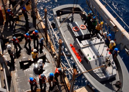 US Navy 081004-N-3392P-038 ailors hoist down a landing craft aboard the amphibious dock landing ship USS Carter Hall (LSD 50)