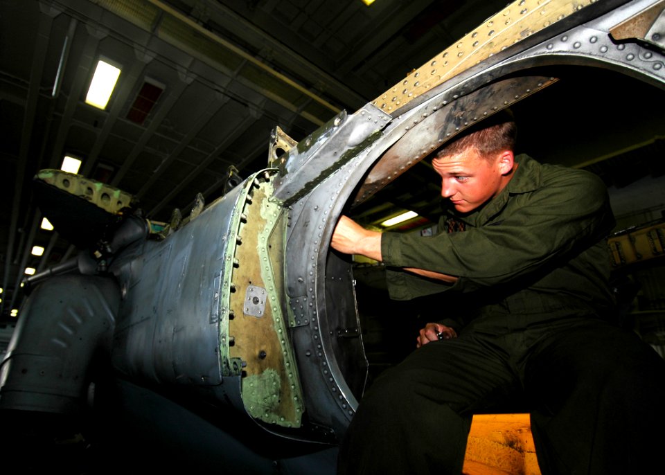 US Navy 081008-N-4236E-011 Cpl. Nathan Feld, assigned to the 26th Marine Expeditionary Unit (26 MEU) performs maintenance on an AV-8B Harrier aboard the multi-purpose amphibious assault ship USS Iwo Jima (LHD 7)