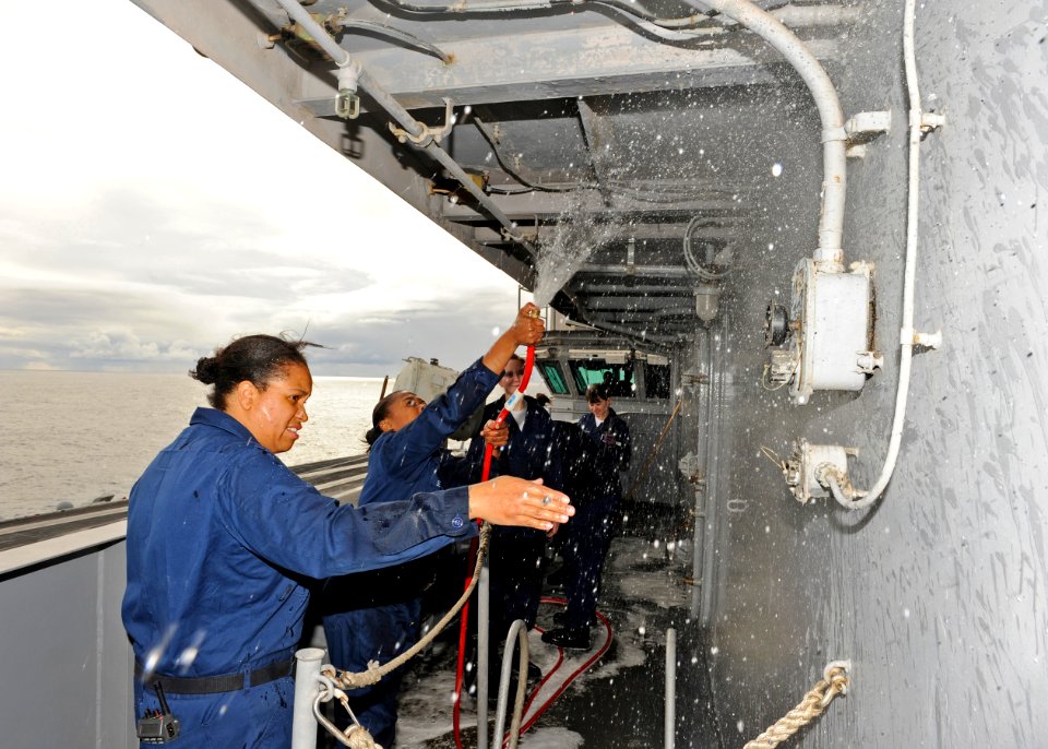US Navy 101213-N-6427M-109 Quartermaster 1st Class Sheryl Gains directs Sailors during a fresh water rinse of the vultures row aboard USS Harry S