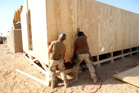US Navy 081006-N-9623R-081 Seabees work constructing the wall on a South West Asia hut photo