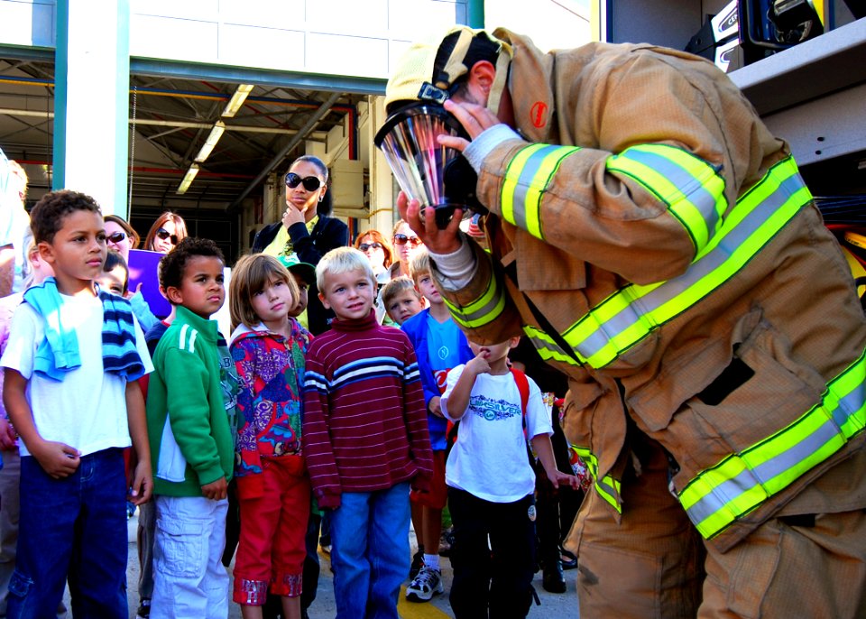 US Navy 081007-N-4044H-251 Firefighter Elio Dentoni shows Naples Elementary School students the protective firefighter suit and the proper way to put it on