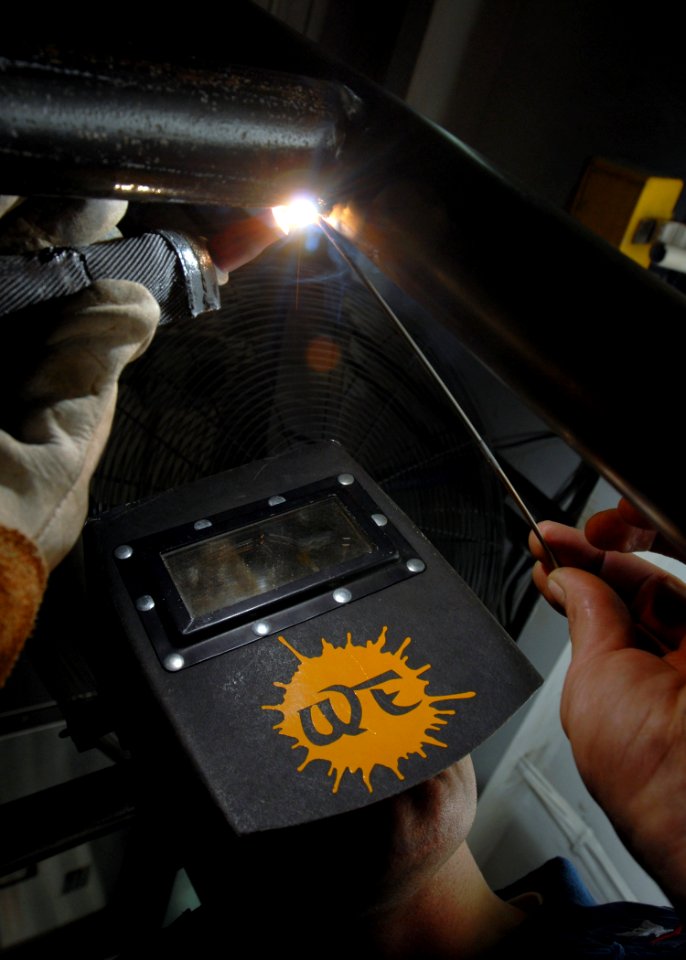 US Navy 081005-N-2456S-025 Hull Maintenance Technician 3rd Class Craig Baker welds a brace for a handrail on the brow of the aircraft carrier USS Theodore Roosevelt (CVN 71)