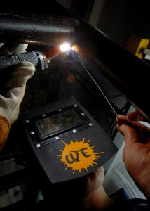 US Navy 081005-N-2456S-025 Hull Maintenance Technician 3rd Class Craig Baker welds a brace for a handrail on the brow of the aircraft carrier USS Theodore Roosevelt (CVN 71)