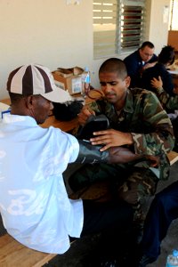 US Navy 081010-N-7955L-009 Lt. Cmdr. Sugat Patel checks the blood pressure of a local resident