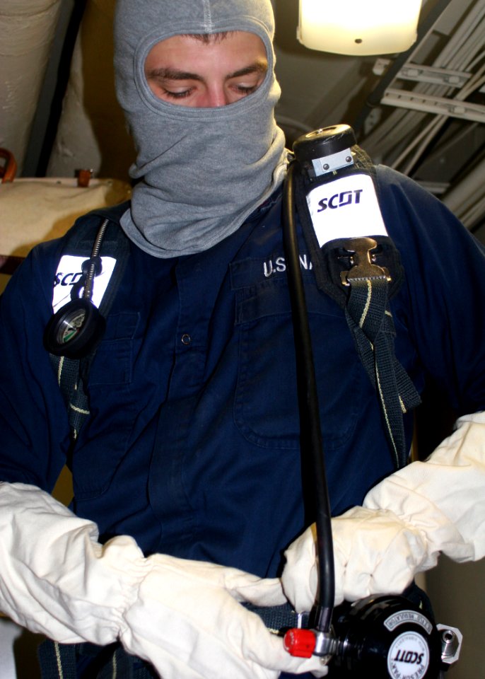 US Navy 081008-N-6764G-059 Electrician's Mate 3rd Class Paul Nipler dons firefighting equipment during a general quarters drill aboard the amphibious transport dock ship USS San Antonio (LPD 17)