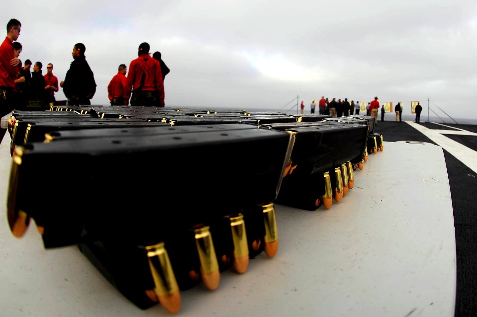 US Navy 081009-N-9928E-005 Sailors assigned to the security division of the operations department aboard the Nimitz-class aircraft carrier USS John C. Stennis (CVN 74) participate in small arms qualifications