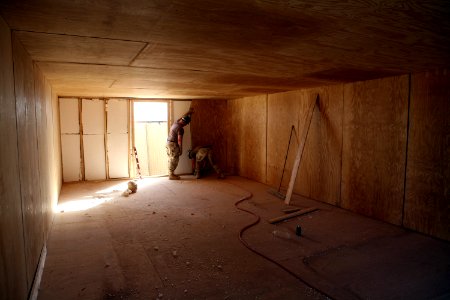 US Navy 081006-N-9623R-325 Seabees put finishing touches on a wall section of one of the South West Asia hut