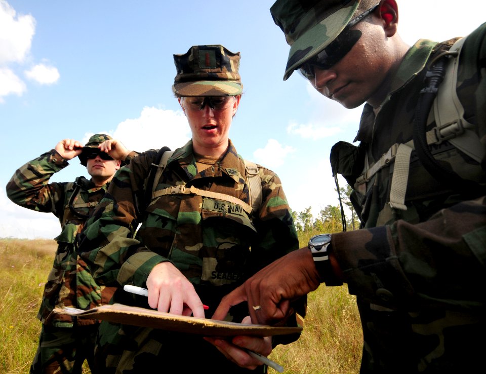 US Navy 081010-N-0411D-008 Equipment Operator Constructionman Jose Torres, right, plots a point on a map with Ens. Jennifer Knop at the beginning of a land navigation exercise during a Navy Expeditionary Combat Skills School tr