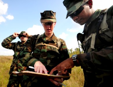 US Navy 081010-N-0411D-008 Equipment Operator Constructionman Jose Torres, right, plots a point on a map with Ens. Jennifer Knop at the beginning of a land navigation exercise during a Navy Expeditionary Combat Skills School tr