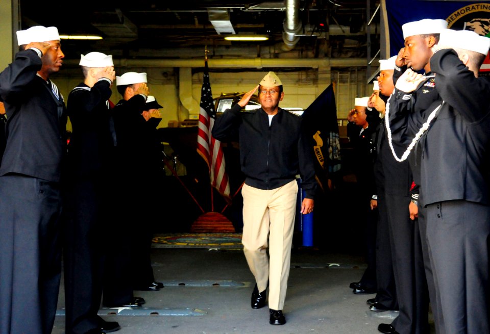 US Navy 081011-N-5758H-024 Vice Adm. Mel Williams Jr. renders a salute to sideboys aboard the amphibious assault ship USS Nassau (LHA 4)