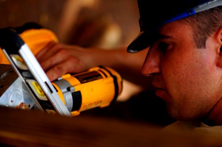 US Navy 081009-N-4515N-117 Air Force Senior Airman Nicholas Varner installs electrical outlets in a school house