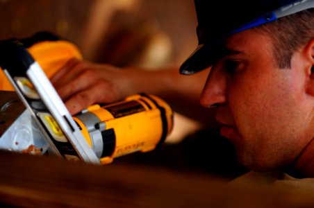 US Navy 081009-N-4515N-117 Air Force Senior Airman Nicholas Varner installs electrical outlets in a school house photo