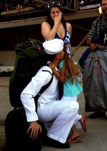 US Navy 081008-N-9898L-046 Aviation Electronics Technician 3rd Class Ross Stowers, from Grove City, Ohio, reunites with his with and daughter after the aircraft carrier USS Abraham Lincoln (CVN 72) moors pier side at Naval Stat