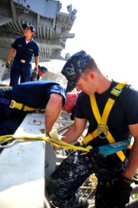 US Navy 101013-N-2953W-927 Sailors perform maintenance on one of the aircraft elevators aboard the aircraft carrier USS Carl Vinson (CVN 70)