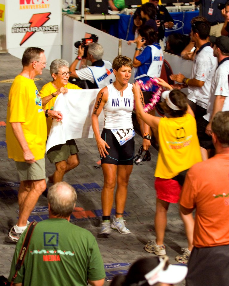 US Navy 081011-N-6674H-005 Cmdr. Kristin Barnes is welcomed with Hawaiian leis as she crosses the finish line at the 30th Ford Ironman World Championship